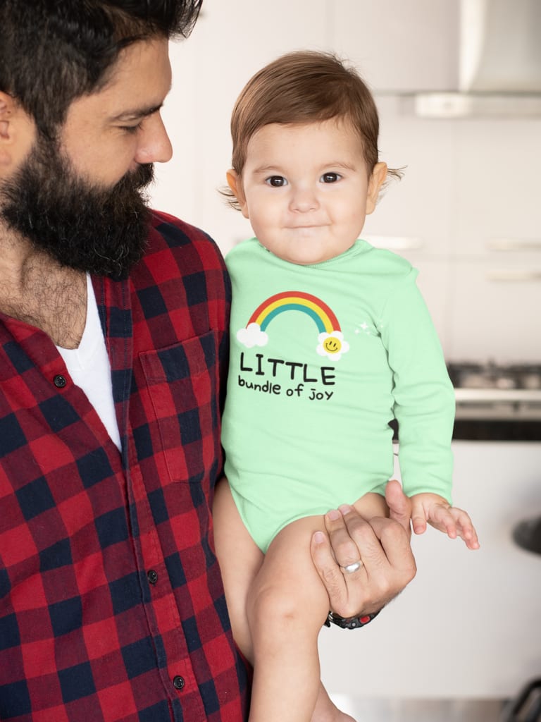 father holding baby wearing mint colored onesie