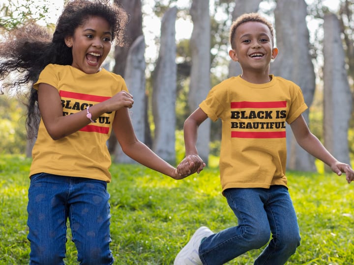 custom black history month shirt of a boy and a girl playing at a  park