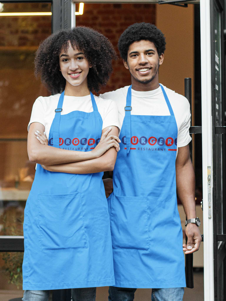 couple wearing matching custom aprons