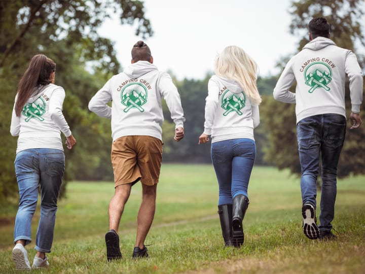 four friends running in the park wearing matching personalized hodies