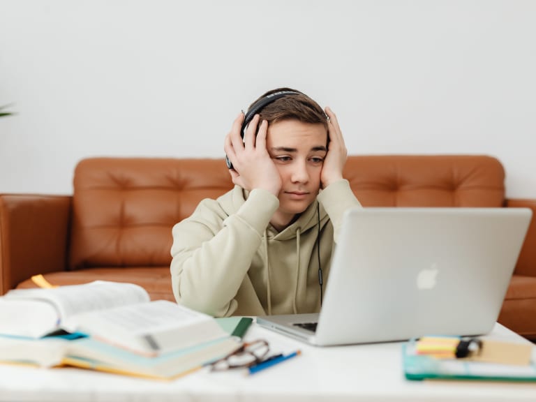 student studying with books and computer