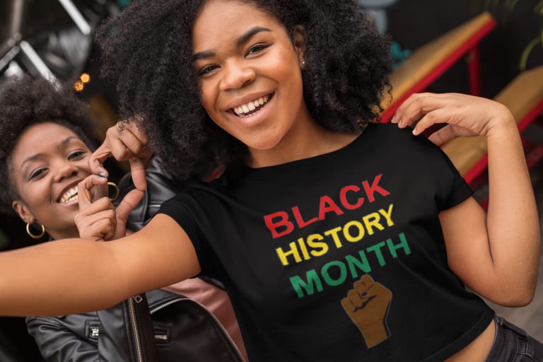 Two Black Women Wearing Black History Month T-shirts