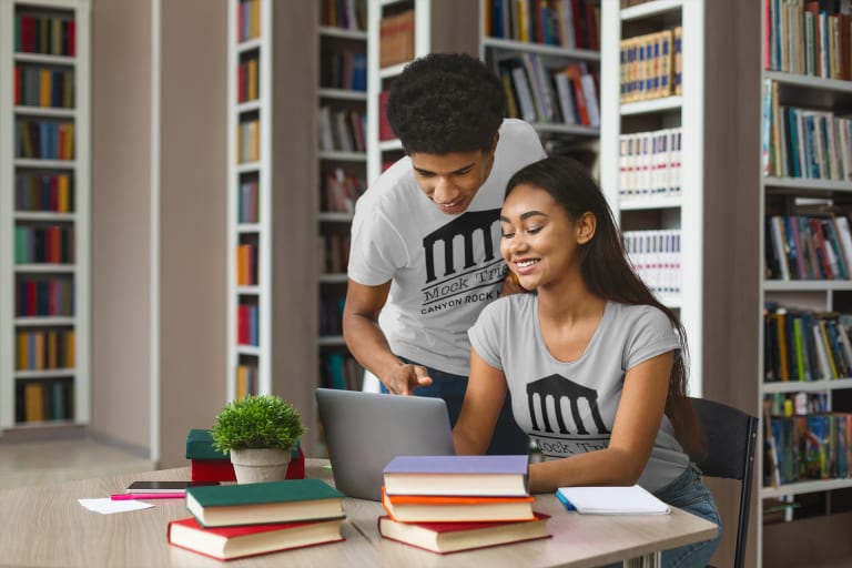Two Students Studying in Custom School T-shirts with Crest