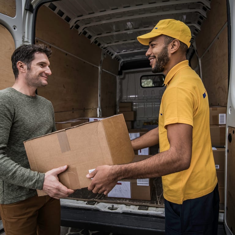 employee handing package to loyal customer