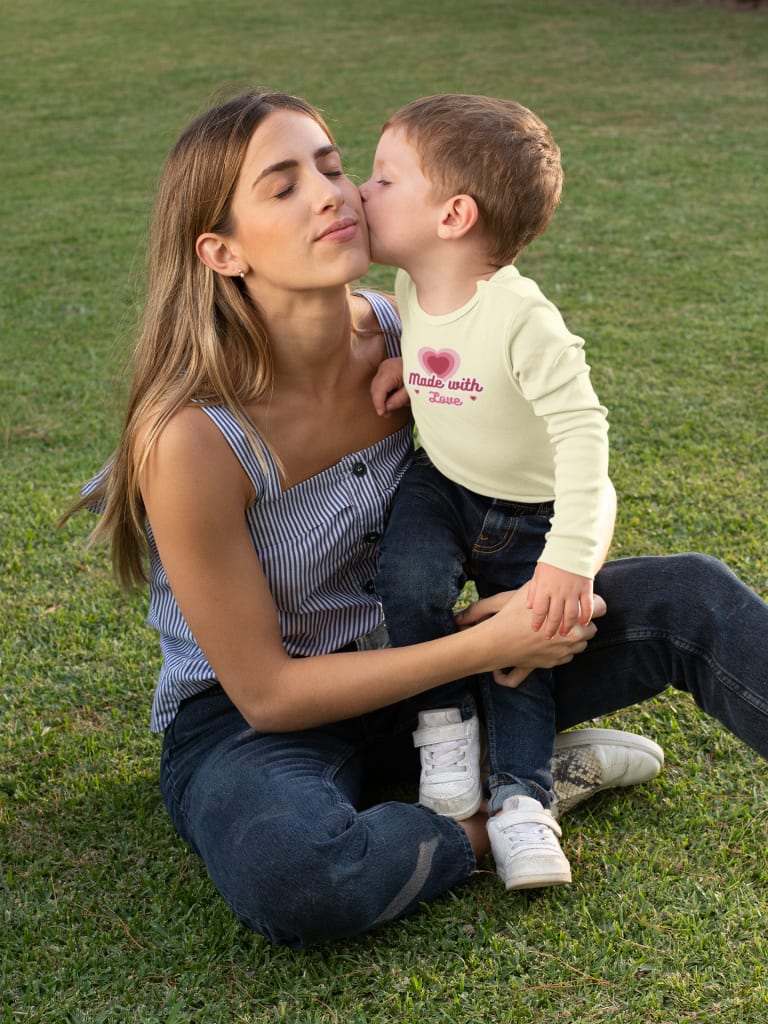 son kissing mom wearing custom printed onesie
