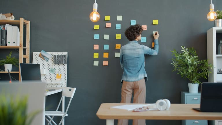 Création d’une matrice de priorisation avec des post-it sur un mur de travail